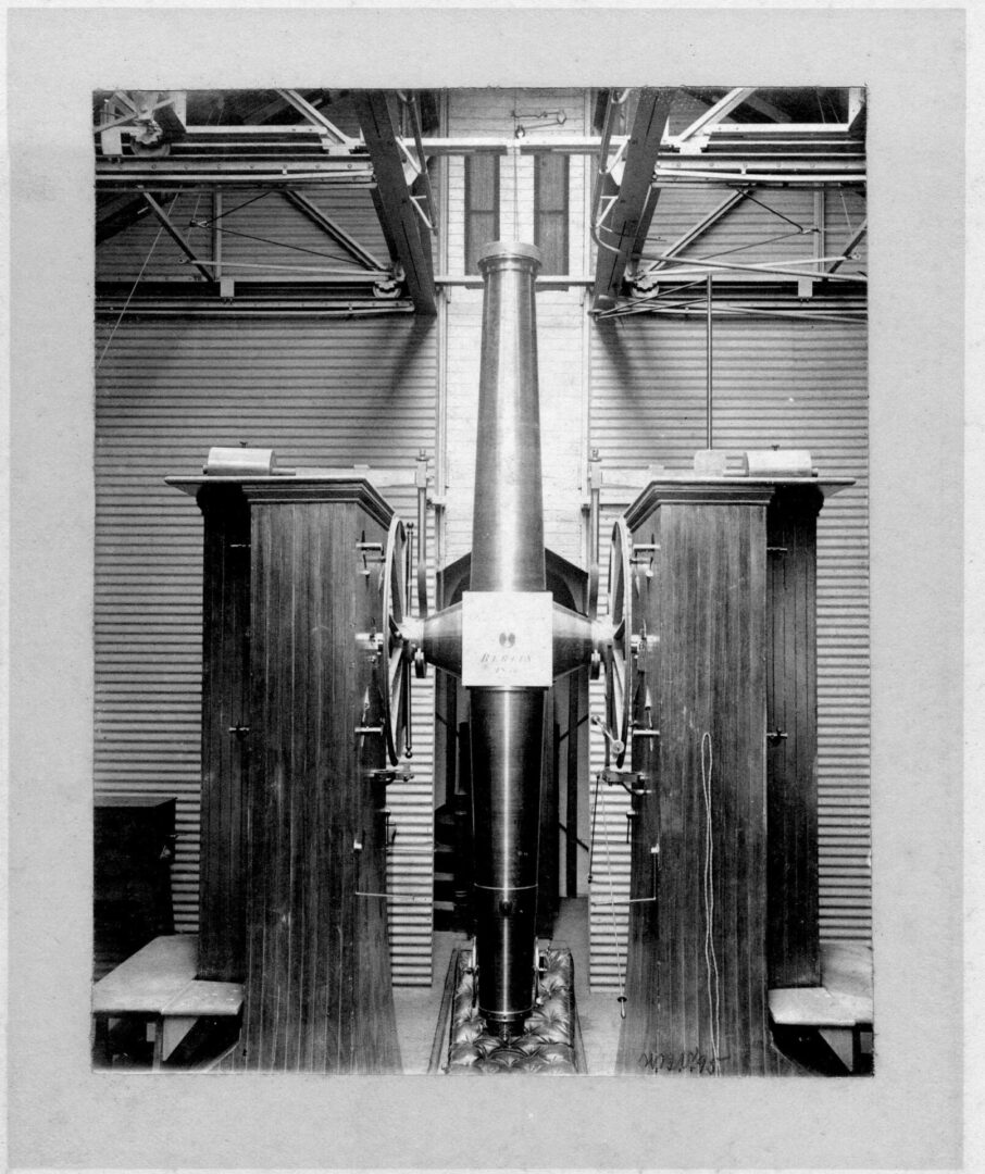 A black and white photo of a large machine in a room.