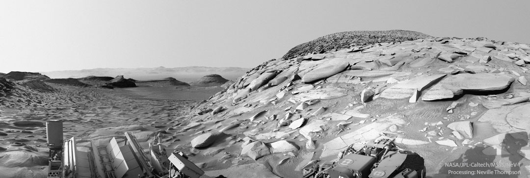 A black and white image of rocks on the surface of nasa's mars rover.